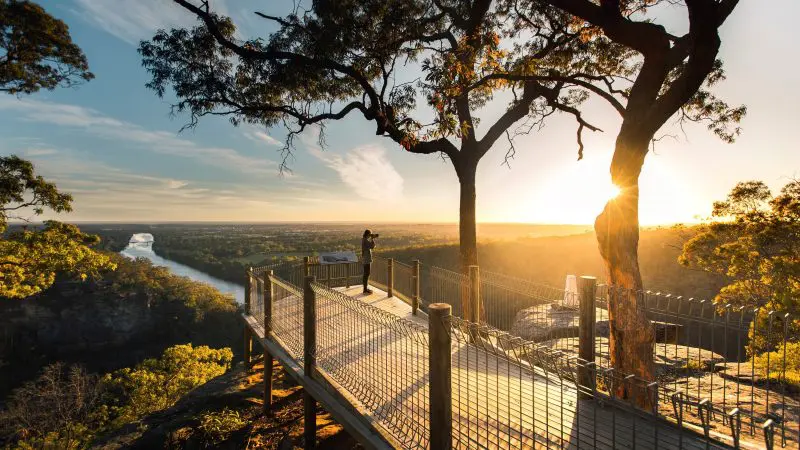 Capture the breathtaking sunrise over a river and valley from a lookout on a 1 Day Blue Mountains Sunset Wilderness Tour.