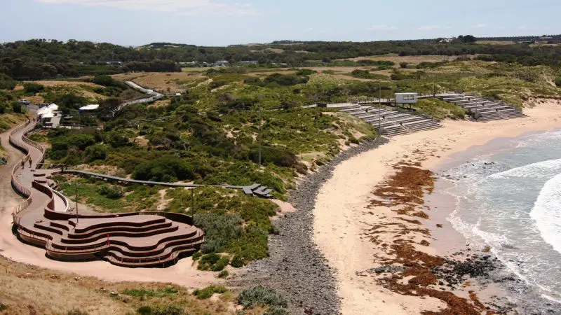 Stunning aerial shot of Phillip Island’s sandy beach and tiered wooden walkways on the 1 Day Penguin Parade Koalas tour experience.