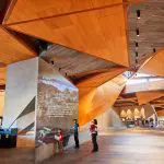 Visitors explore a modern museum foyer exhibit after returning from a Phillip Island Penguin Parade and Koala tour day trip.