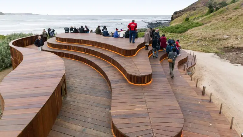 Serpentine wooden boardwalk with visitors admiring stunning ocean views on the Phillip Island Penguin Parade and Koalas tour day trip.