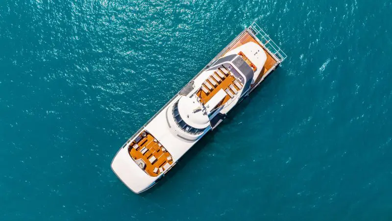 A large open topped vessel visiting Whitehaven Beach on a Whitsundays day trip