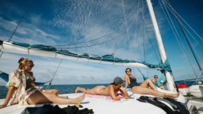 people sunbaking in the whitsundays on the bow of summer jo