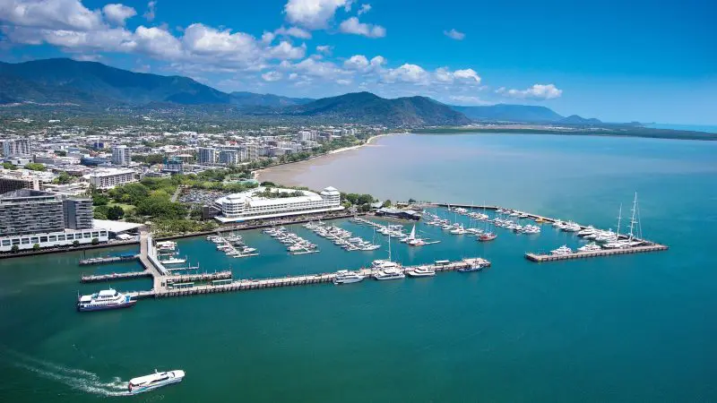 Stunning aerial view of Port Douglas marina with yachts, waterfront cityscape—ideal for a 3 Day Daintree Cape Tribulation tour.