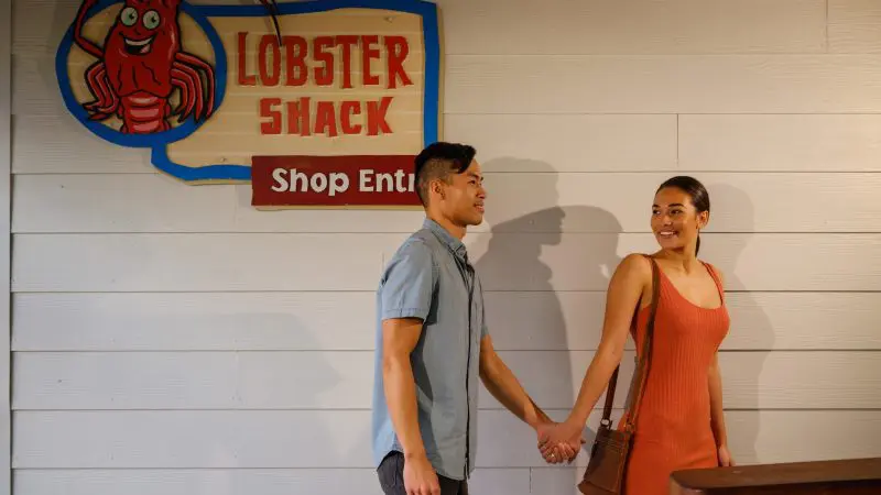 Smiling couple holding hands outside a Lobster Shack, a must-visit highlight on the 8 Day Perth to Exmouth Comfort Tour in Western Australia.