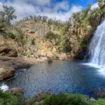 Experience a breathtaking waterfall cascading into a rocky pool in the Grampians—ideal for your unforgettable 1 Day Eco Wilderness Escape.