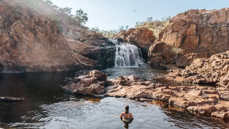 Experience swimming in a pristine natural pool beneath rugged cliffs and a cascading waterfall on your Katherine Gorge Edith Falls tour.