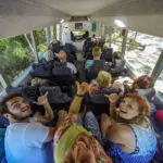 a grop of backpackers exploring K'gari on a bus with Peterpans