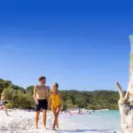 Twop backpackers exploring K'gari at Lake Mckenzie with Peterpans