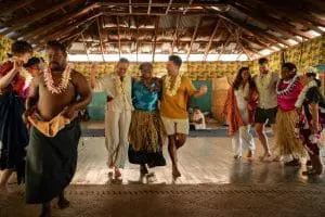 Image of travellers dancing with locals in Fiji during their village tour to experience local cultures and ceremonies 