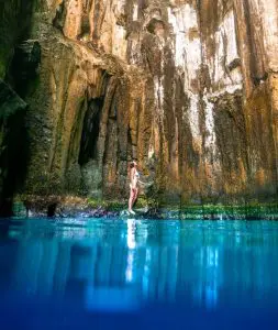 Woman standing in the Sawa I Lau Caves in the Blue lagoon region in fiji