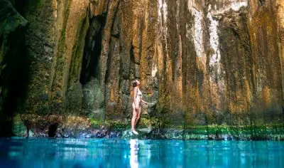 Woman standing in the Sawa I Lau Caves in the Blue lagoon region in fiji
