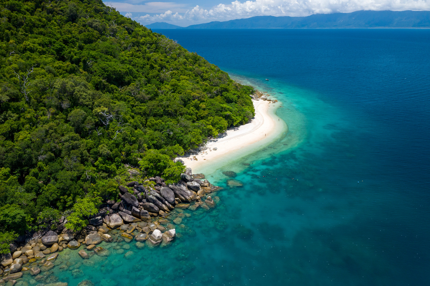Stunning aerial view of Fitzroy Island, showcasing lush greenery, pristine sandy beaches, and crystal-clear turquoise waters.