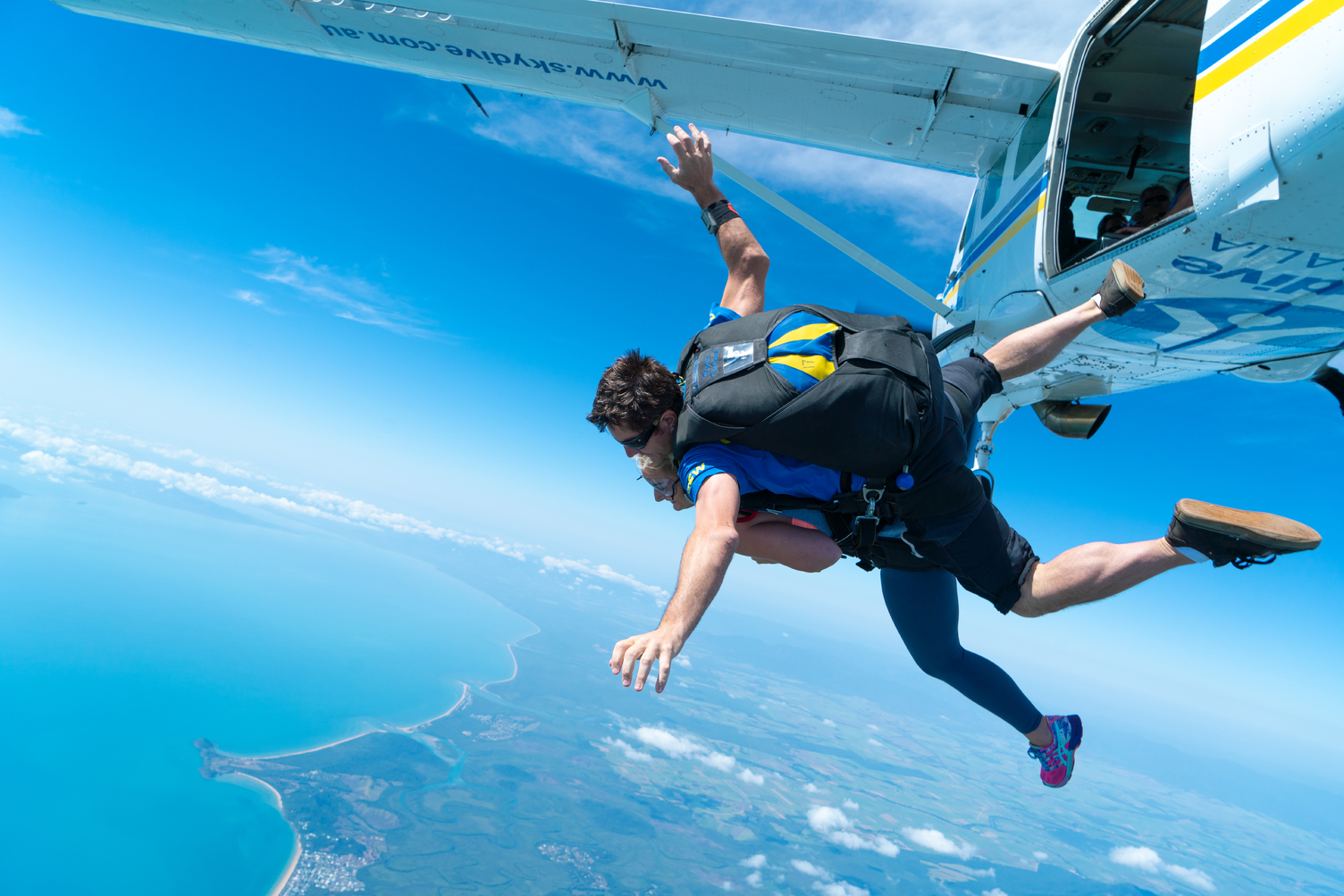 Experience an exhilarating Mission Beach tandem skydive up to 15,000ft over breathtaking coastline, clear blue sky, and ocean views.