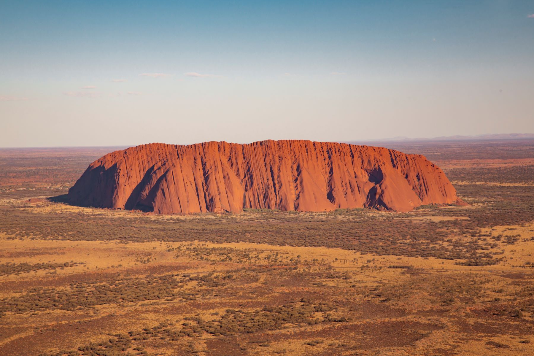 Uluru, the majestic red sandstone monolith, towers over Australia’s outback on the 7 Day Uluru to Adelaide Experience by Untamed Escapes.