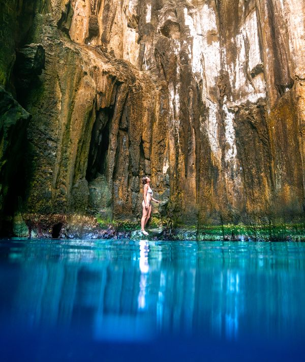 Woman standing in the Sawa I Lau Caves in the Blue lagoon region in fiji